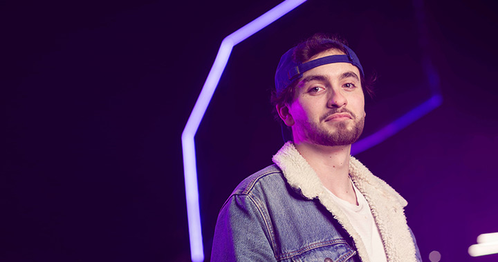 A student smiling at the camera against an LED background. A student smiling at the camera against an LED background.